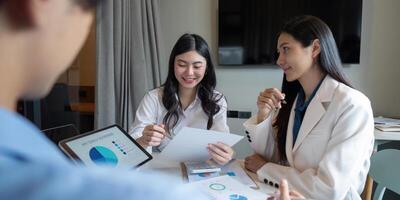 Business Team Collaboration on Data Analysis in Modern Office Setting with Charts and Graphs photo