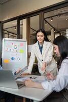 Business Team Collaboration on Data Analysis in Modern Office Setting with Charts and Laptops photo
