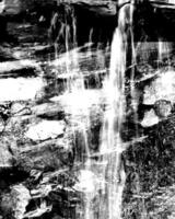 Waterfall and the mountain river background. Waterscape natural environment black and white photo background