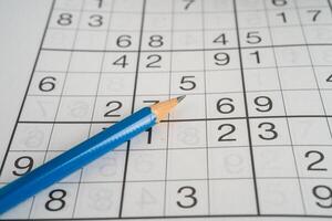 Sudoku puzzle game playing to challenge brain. photo