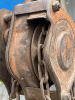 old rusty metal reel and chain photo
