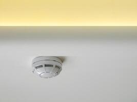 fire alarm sensor on the ceiling with LED lighting photo