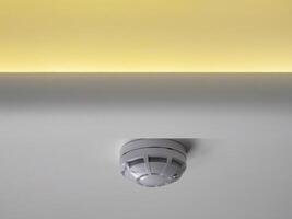 fire alarm sensor on the ceiling with LED lighting photo