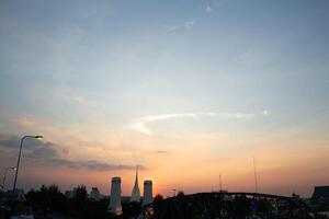 orange blue skyscape background with cloud and silhouette city town building in evening of the day sunset twilight dusk time photo