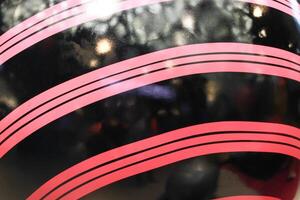 Curved colored lines on a circular object ball with reflection of bokeh light festive photo