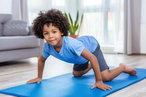 Active kid - african american boy trains in home for physical development photo
