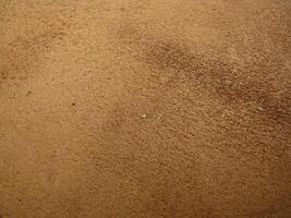 a close up of a brown leather surface photo