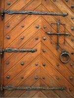 an old wooden door with iron hardware photo