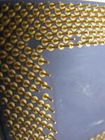 a close up of a computer chip with gold pins photo