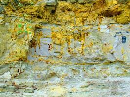 a rock wall with graffiti on it photo