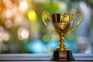 Gold trophy on a table with a blurry background photo
