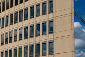 large building with many windows and a crane in the background photo