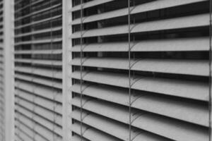 image is a close up of a window with white blinds photo