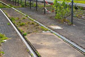 train track with a fence and chain link fence photo