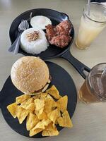 two portions of food, namely burgers and chicken cheese and rice. top view. photo