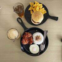 two portions of food, namely burgers and chicken cheese and rice. top view. photo