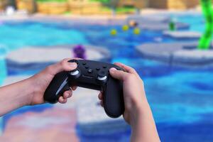 Child holding a gamepad with gameplay on a big screen in the background. Gaming, technology, and family entertainment content photo