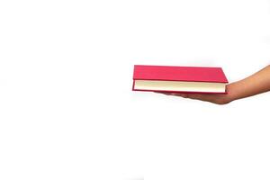 The hand of a person giving a book or sharing books on white background. exchanging knowledge and education concept. photo