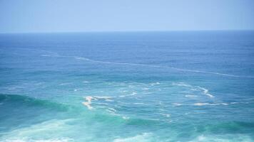Front view over the ocean and white foam waves. Feel calm, cool, relaxed. Idea for cool background and copy space above. photo
