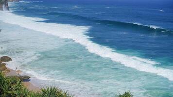 view of rolling waves and ocean from the top front view and surrounded by green plants. The beach is very beautiful. Idea as background, holiday, poster photo