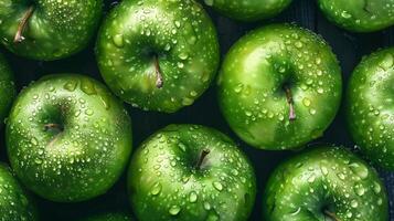 A bunch of green apples with water droplets on them photo