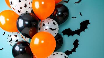 A bunch of orange and black balloons with black bats scattered around them photo