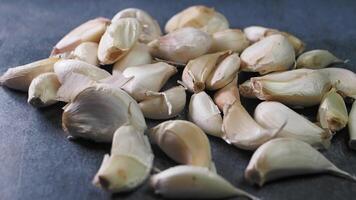 close up pf garlic dropping on a table video
