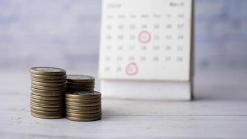 stack of coins and calendar on table video