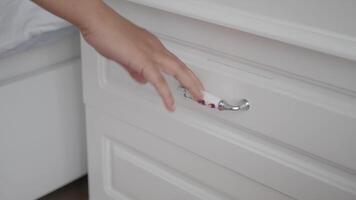 man's hand open drawer wooden in cabinet video