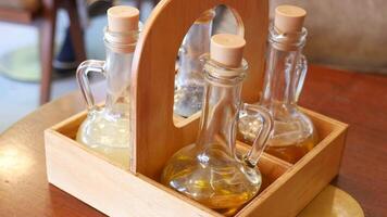 bottle of olive oil , lemon and soya sauce on table video