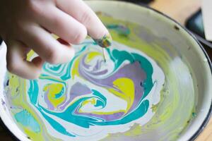 Process of creating painting in ebru technique. photo