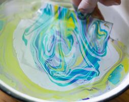 Process of creating painting in ebru technique. photo