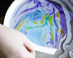 Process of creating painting in ebru technique. photo