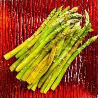 Green grilled asparagus on a red plate photo
