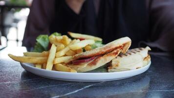 sandwich or toast with sausage served on a plate on tiles background video