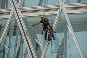Italy 2024 A rope operator with a harness, lowering himself onto the facade of a building photo