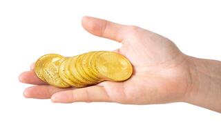 Someone hand holding some pieces of golden Bitcoin token isolated on white background. Bitcoin is one of the popular cryptocurrency, a virtual currency or a digital currency. photo