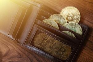 Group of Bitcoin token in leather wallet. Bitcoin is one of the popular cryptocurrency, a virtual currency or a digital currency. photo