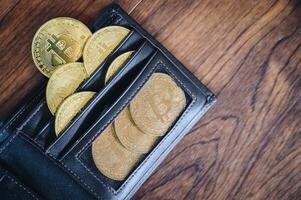 Group of Bitcoin token in leather wallet. Bitcoin is one of the popular cryptocurrency, a virtual currency or a digital currency. photo