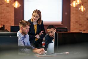 Strategic Business Meeting. Group of Professionals Collaborating in Office Using Computers photo