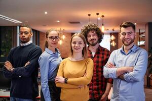 Portrait of successful creative business team looking at camera and smiling. Diverse business people standing together at startup. Selective focus photo