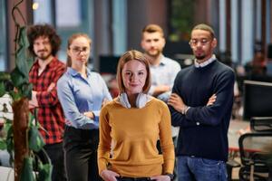 Portrait of successful creative business team looking at camera and smiling. Diverse business people standing together at startup. Selective focus photo