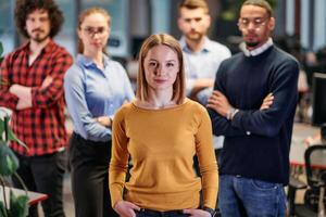 Portrait of successful creative business team looking at camera and smiling. Diverse business people standing together at startup. Selective focus photo