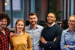 Portrait of successful creative business team looking at camera and smiling. Diverse business people standing together at startup. Selective focus photo