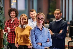 Portrait of successful creative business team looking at camera and smiling. Diverse business people standing together at startup. Selective focus photo