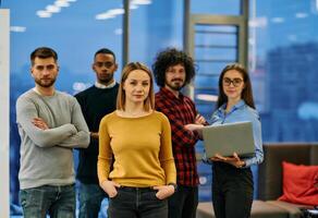 Portrait of successful creative business team looking at camera and smiling. Diverse business people standing together at startup. Selective focus photo