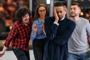 A group of young business people have fun playing interesting games while taking a break from work in a modern office. Selective focus photo