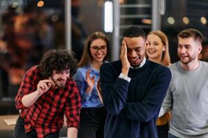 A group of young business people have fun playing interesting games while taking a break from work in a modern office. Selective focus photo