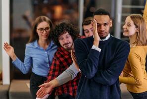 A group of young business people have fun playing interesting games while taking a break from work in a modern office. Selective focus photo