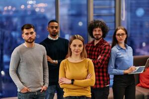 Portrait of successful creative business team looking at camera and smiling. Diverse business people standing together at startup. Selective focus photo